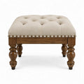 Beige gecapitonneerde voetenbank met donkerbruine houten poten, 90 x 90 x 48 cm